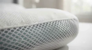 Detailed view of the breathable mesh side gusset on a temperature-regulating gel memory foam pillow.