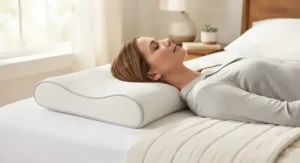 A slim cervical contour pillow for back sleepers resting on a white bedroom background.