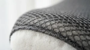 Close-up of the mesh cover on a pillow to reduce snoring for side sleepers.