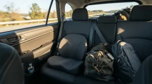 A portable travel CPAP pillow sitting on the back seat of a car during a cross-country road trip.